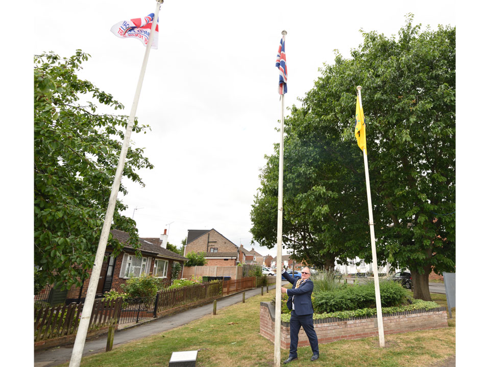Whitnash Mayor Cllr Adrian Barton raises the Armed Forces Flag